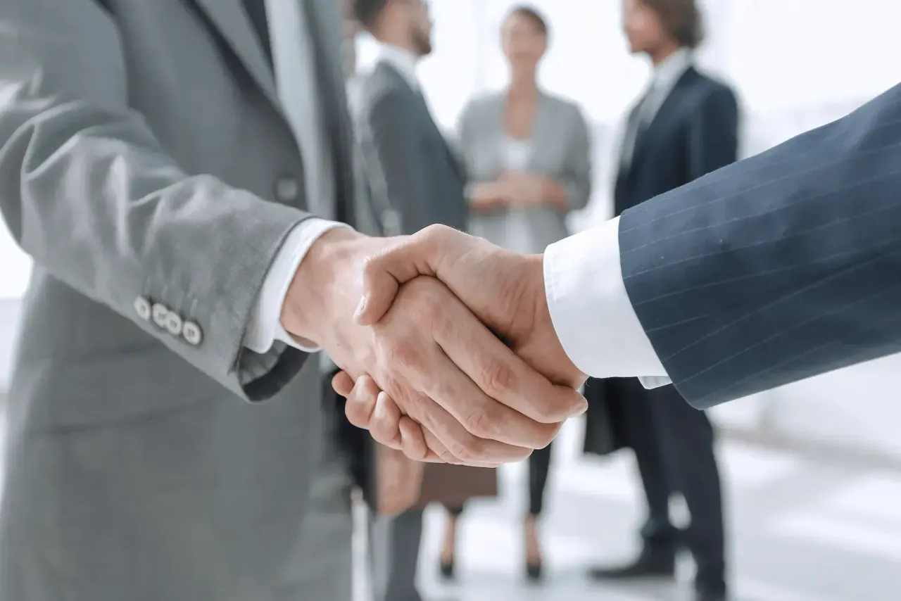 Two businesspeople shaking hands. Two businesspeople shaking hands.